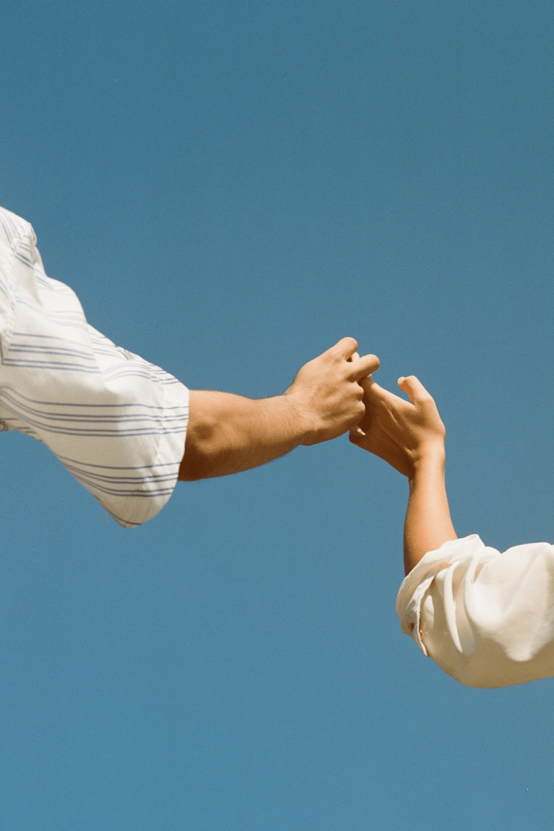 Two people holding hands after trauma counseling near me