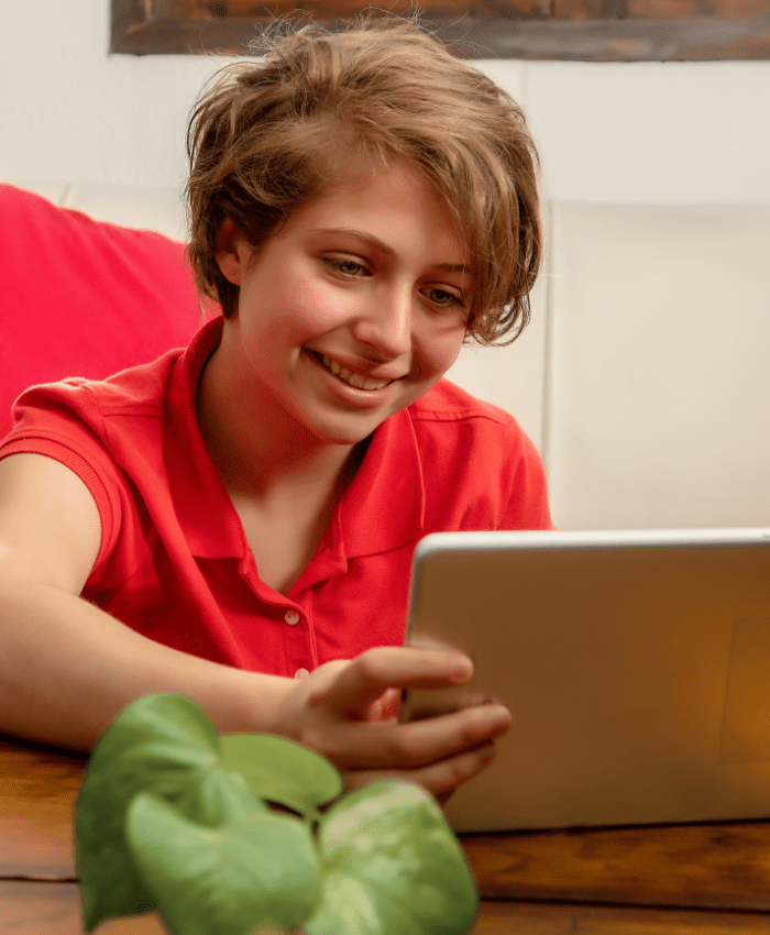 adolescent mental health treatment teen using tablet at home